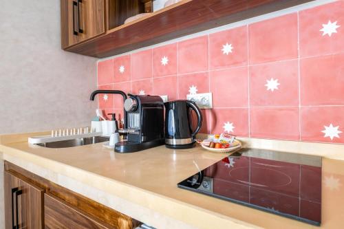 a kitchen with a sink and a coffee maker on a counter at Studio JOSAFAT Medina Tanger in Tangier