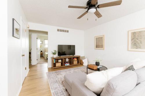 a living room with a white couch and a ceiling fan at 5 Min to Adventureland and Casino - Fenced in yard in Altoona
