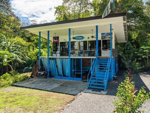 a small building with blue stairs in front of it at Sea View Modern dream House in Pavones