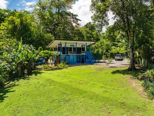 a small blue house with a grass yard at Sea View Modern dream House in Pavones
