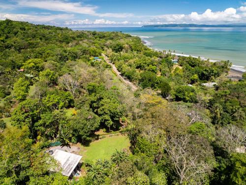 an aerial view of a forested area next to the ocean at Sea View Modern dream House in Pavones