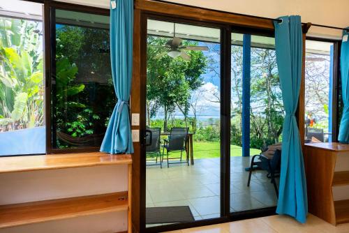 a sliding glass door with a view of the garden at Sea View Modern dream House in Pavones