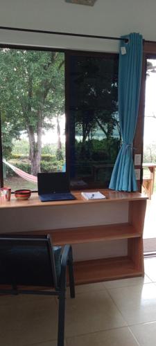 a desk with a laptop sitting on top of it at Sea View Modern dream House in Pavones
