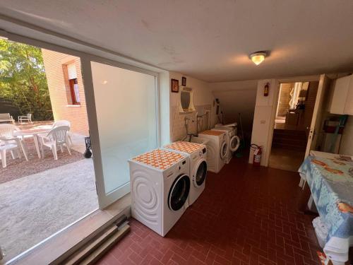 two washing machines in a room with a patio at Residence Casa Pineta in Principina a Mare