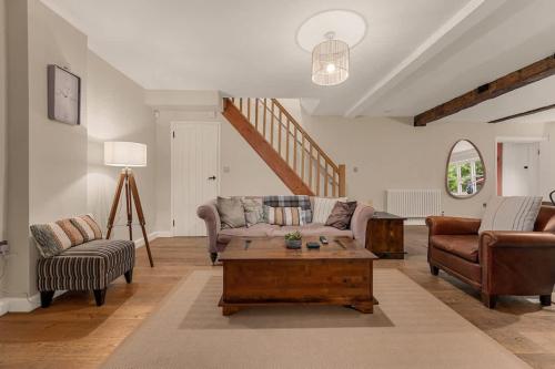 a living room with a couch and a coffee table at Stunning Bowdon Cottage by City SuperHost in Bowdon