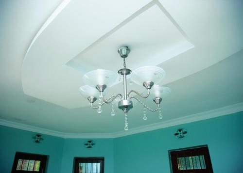 a ceiling with a chandelier in a room at Ngorongoro Villa and Restaurant in Karatu