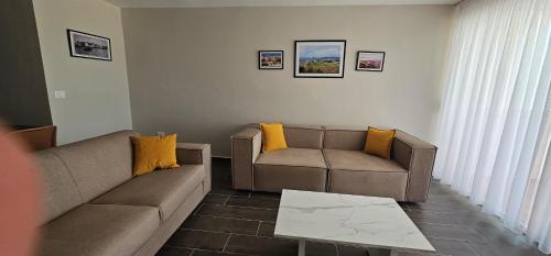 a living room with a couch and a table at Sandy Vibes Apartments in Durrës