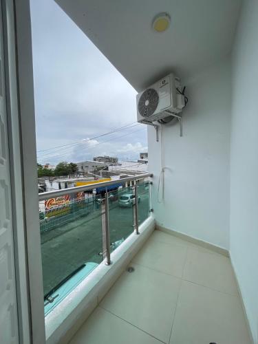 a room with a balcony with a view of a city at DuoCentro - Apartamento en el Punto Ideal in Montería