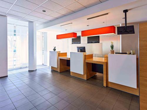 an office with desks and cabinets in a room at B&B Hotel Bonn-City in Bonn