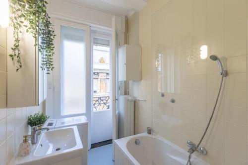 a bathroom with a tub and a sink and a shower at TOP Location Studio at Deák Sqr in Budapest