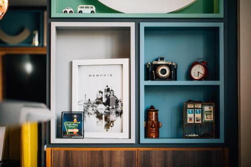a shelf with a picture and a camera on it at Holiday Inn Belfast by IHG in Belfast