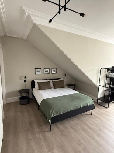 a bedroom with a large bed in a attic at Park House Rooms - Sky TV and kitchenette in Aberdeen
