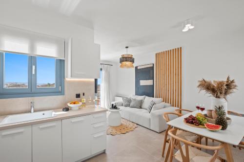 a kitchen and living room with a couch and a table at Coastal Retreat Naxos in Naxos Chora