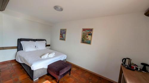 a small bedroom with a bed and a chair at Castle view by MK in Montreux