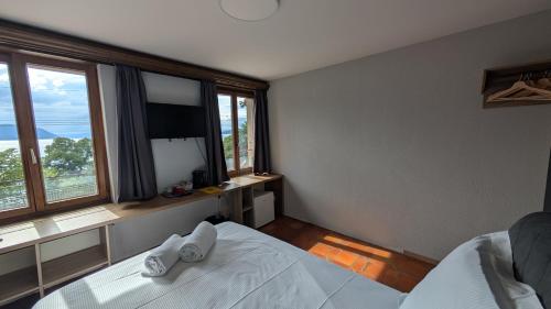 a bedroom with a white bed and a large window at Castle view by MK in Montreux