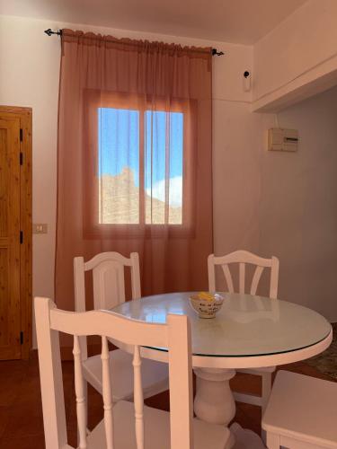 a white table and chairs in a room with a window at Nature in Tejeda in Tejeda