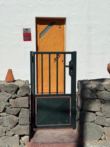 a door to a building with a stone wall at Nature in Tejeda in Tejeda