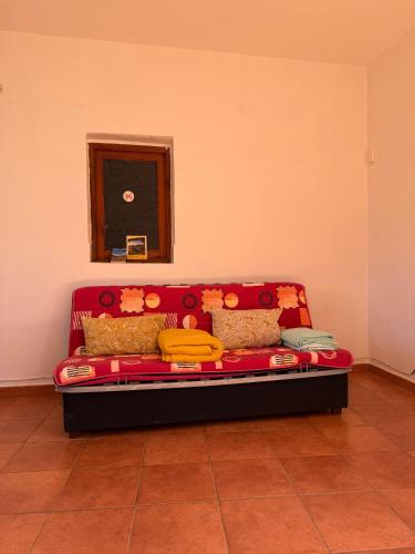 a red couch in the corner of a room at Nature in Tejeda in Tejeda