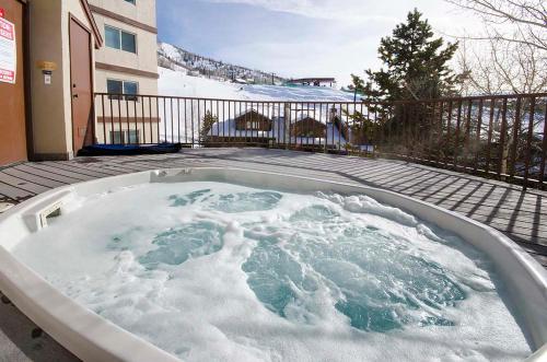a jacuzzi tub filled with snow in front of a building at Updated 2 Bed 2 Bath Ski In Ski Out with King Beds, Hot Tub, Private Balcony in Steamboat Springs