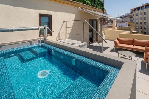 a swimming pool on the roof of a house at Catalonia Excelsior in Valencia