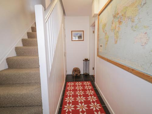 a hallway with a map on the wall and a red carpet at The Burma in Letterkenny