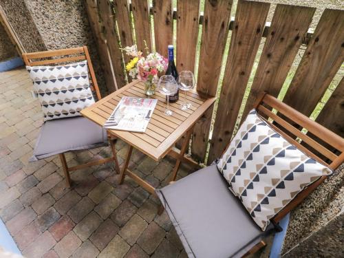a table and chairs on a patio with flowers on it at The Burma in Letterkenny