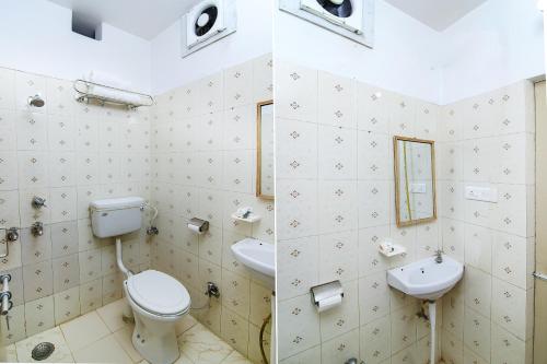 a bathroom with a toilet and a sink at HOTEL O JMD INN in Gomti Nagar