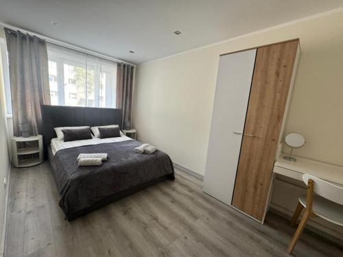 a bedroom with a bed and a large mirror at Southwest Sea Apartment in Liepāja