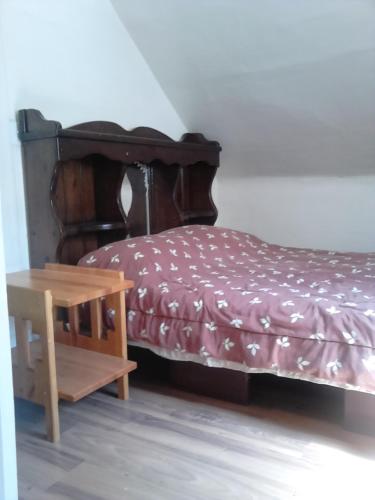 a bed and a wooden table in a room at Canora Vacation Home in Canora