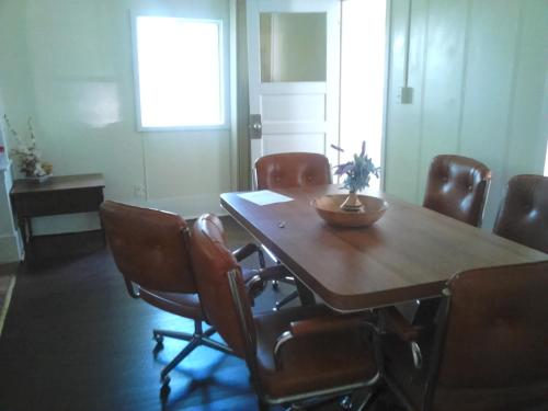 a conference room with a wooden table and chairs at Canora Vacation Home in Canora
