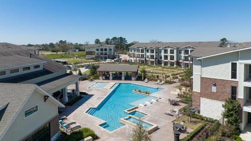 an aerial view of a pool at a apartment complex at Landing Stunning 1BD Clubhouse Gym in Katy