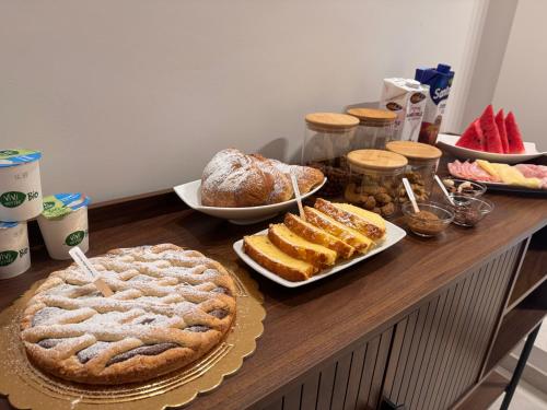 einen Tisch mit Kuchen und anderen Lebensmitteln darauf in der Unterkunft Amarcord in Laureana di Borrello