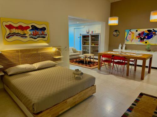 a bedroom with a bed and a dining room at Le More Apartment in Rutigliano