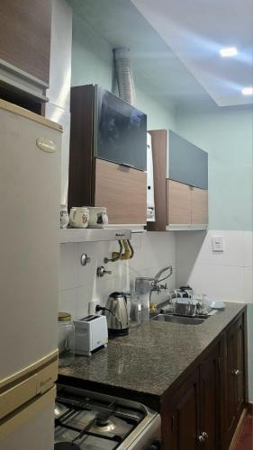 a kitchen with a stove and a counter top at Sueños del Valle in San Fernando del Valle de Catamarca