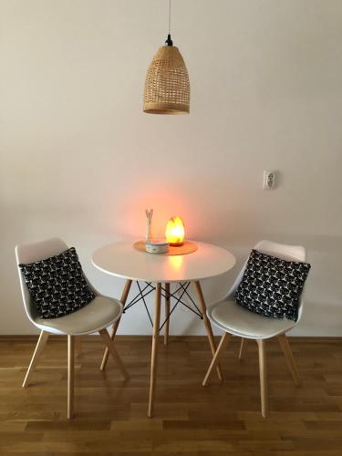 a table and two chairs with a candle on it at Tesla 30 in Kruševac