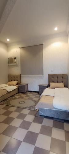 a room with two beds and a projection screen at استراحة الشيوخ in Taif