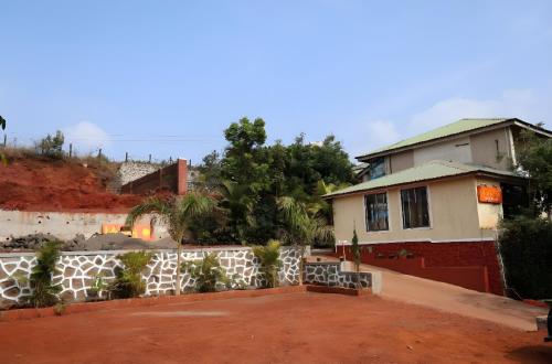 a house with a fence in front of it at Maitri Retreat in Panchgani