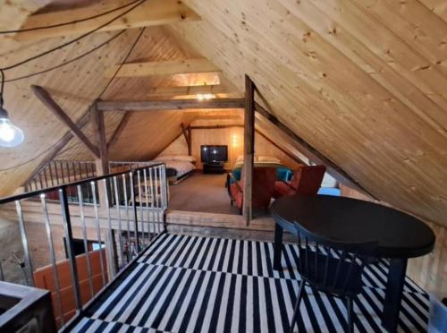 a attic room with a bed and a table in a room at Studio 611 in Třebíč
