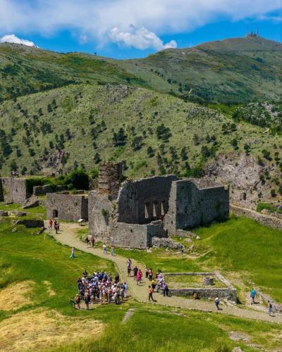 a group of people standing in front of an old building at Golden Sleep Hostel in Shkodër