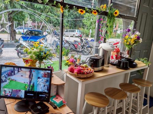 a computer monitor sitting on a desk in front of a window at Sleepymoon Hostel in Thongsala