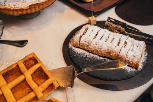 a piece of cake and a waffle on a plate at Euro Hotel in Imola