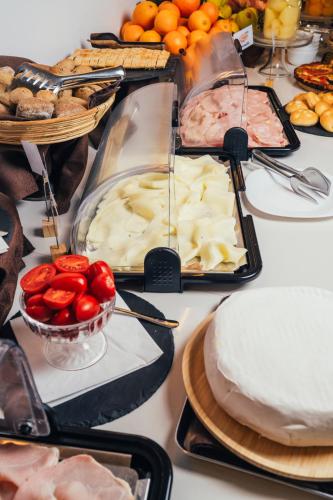 a table with many different types of food on it at Euro Hotel in Imola