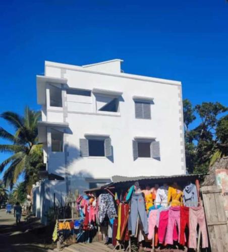 a display of clothes in front of a white building at Chez Pauline in Sainte Marie