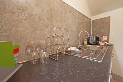 a kitchen counter with a sink and some glass dishes at Compton House Snug in Newark upon Trent