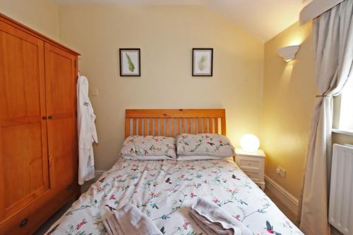 a bedroom with a bed with a wooden headboard at Compton House Snug in Newark upon Trent