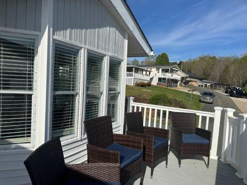 a group of chairs sitting on a porch at Badin Shores Resort - Excellent Lake View Home - Pools & Lots of Amenities - Great Porch Area - Family in New London
