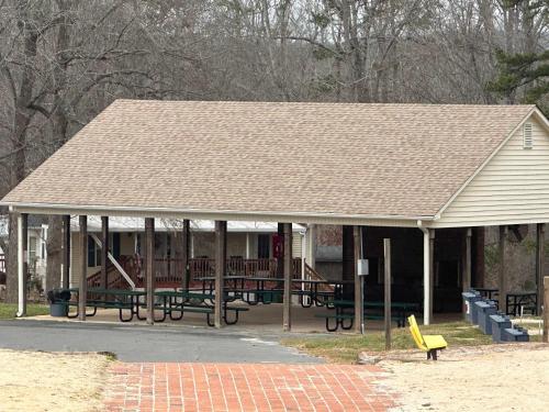 a pavilion with tables and benches in a park at Badin Shores Resort - Excellent Lake View Home - Pools & Lots of Amenities - Great Porch Area - Family in New London