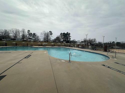 a large empty swimming pool in a park at Badin Shores Resort - Excellent Lake View Home - Pools & Lots of Amenities - Great Porch Area - Family in New London