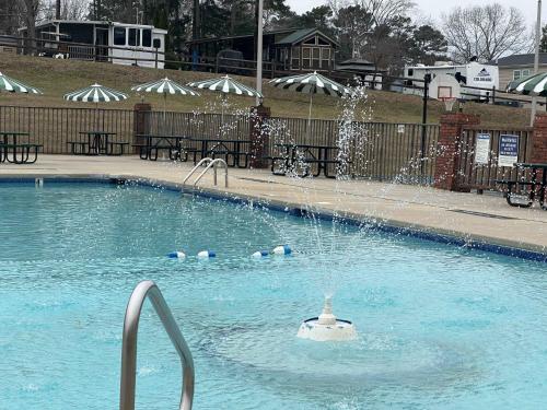 a pool with a fountain in the middle of it at Badin Shores Resort - Excellent Lake View Home - Pools & Lots of Amenities - Great Porch Area - Family in New London