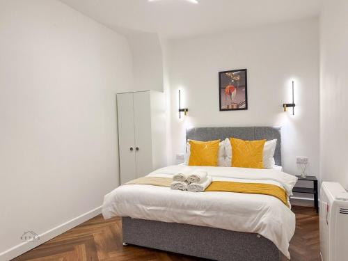 a bedroom with a large bed with two shoes on it at Modern 2 Bedroom Flat in Luton Town Centre in Luton